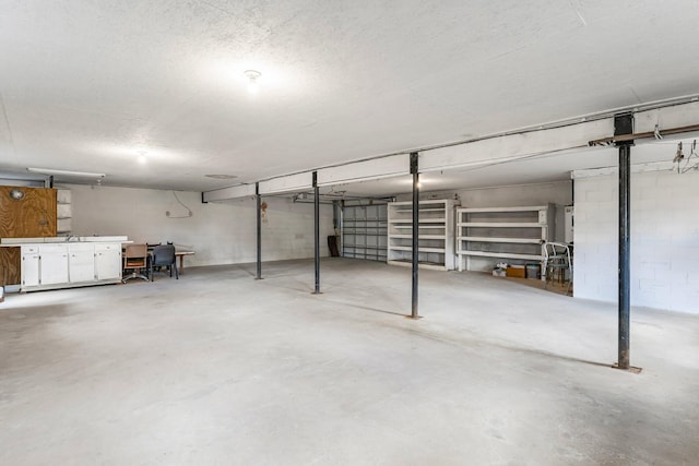 below grade area with a textured ceiling and concrete block wall