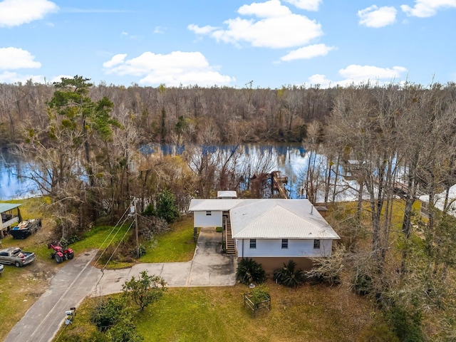 drone / aerial view featuring a water view and a view of trees