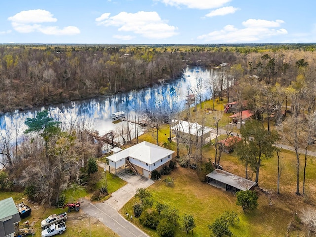 drone / aerial view featuring a water view and a view of trees