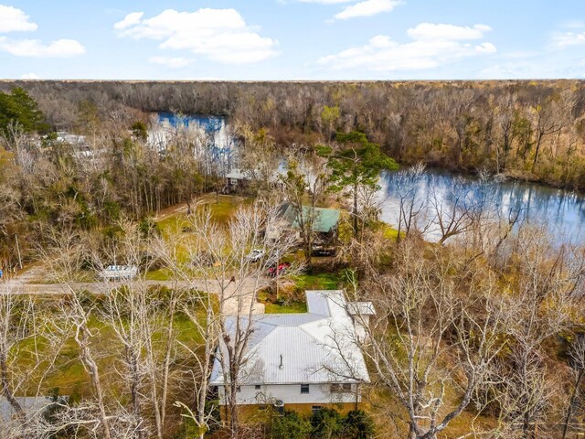 bird's eye view with a water view and a wooded view