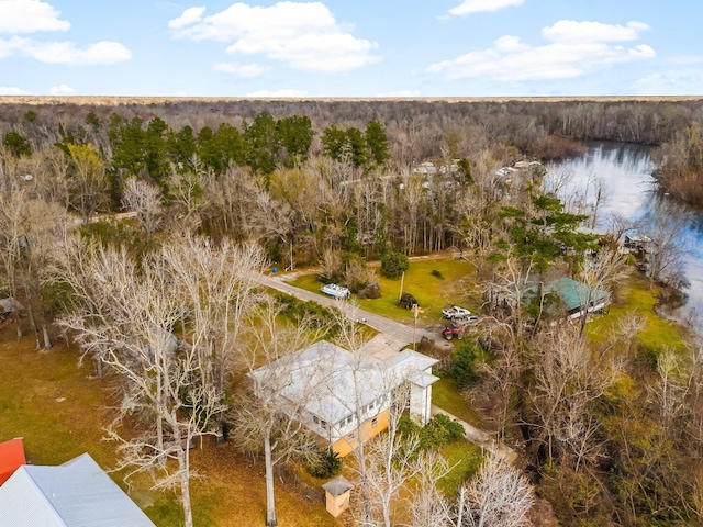 drone / aerial view with a water view and a forest view