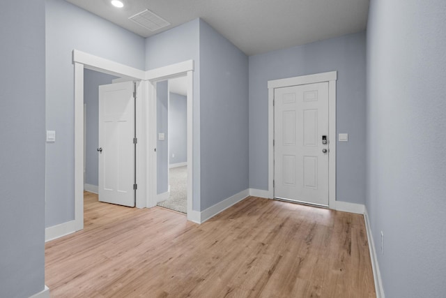 foyer with recessed lighting, baseboards, visible vents, and light wood-type flooring