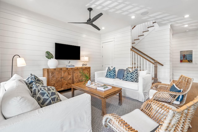 living room featuring a ceiling fan, recessed lighting, and stairs