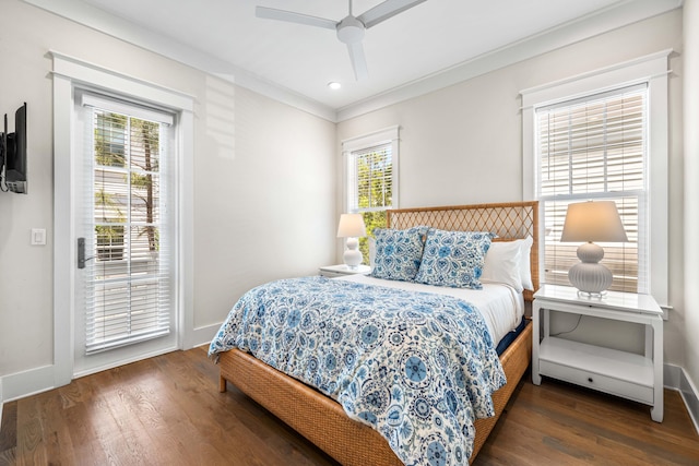 bedroom featuring access to outside, multiple windows, wood finished floors, and crown molding