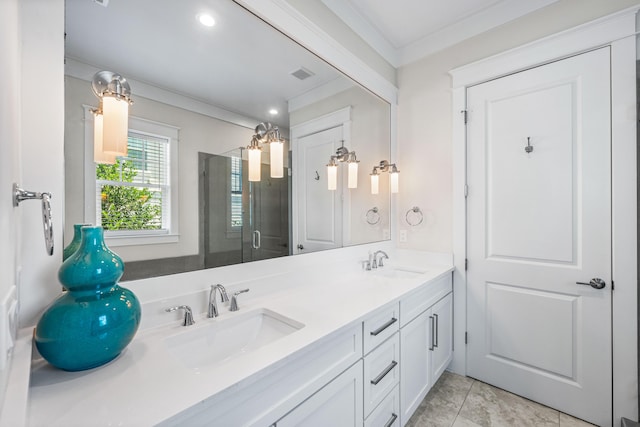 full bathroom featuring crown molding, double vanity, a sink, and a shower stall