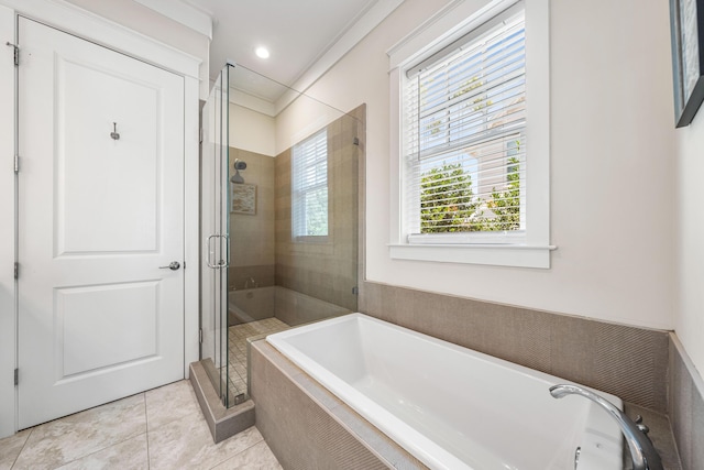 bathroom featuring a stall shower, a garden tub, and tile patterned floors