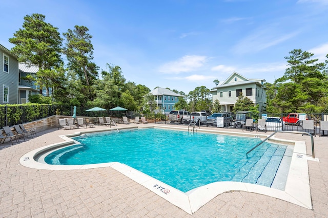 pool featuring a patio area and fence