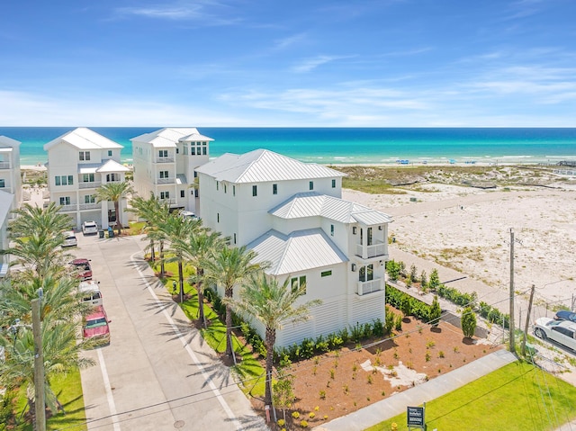 drone / aerial view featuring a water view and a beach view