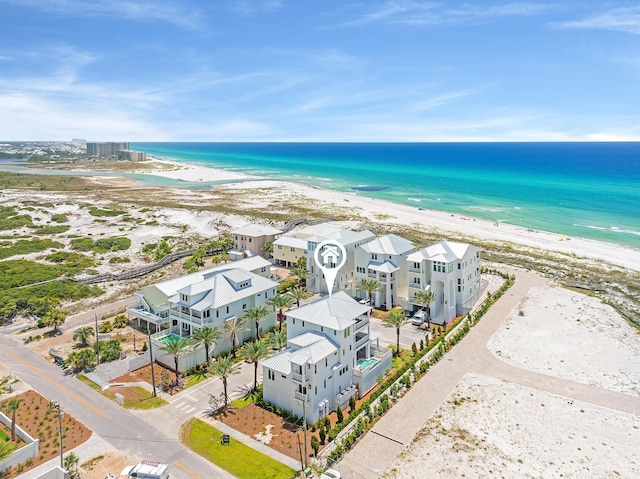 aerial view with a water view and a beach view