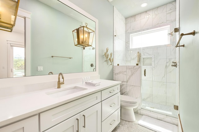 bathroom with toilet, a stall shower, and vanity