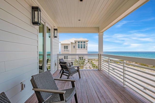 balcony with a beach view and a water view