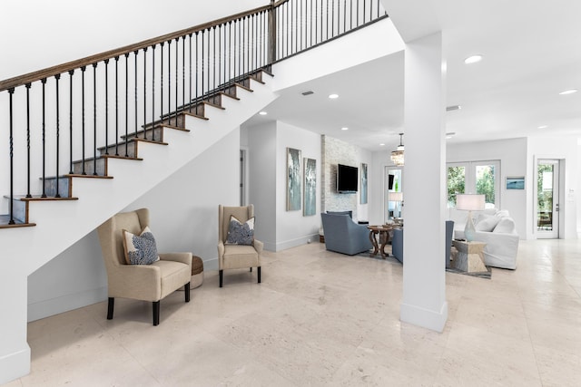 interior space with stairs, a high ceiling, baseboards, and recessed lighting