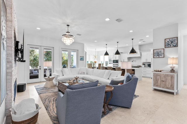 living area with a chandelier, recessed lighting, french doors, and visible vents