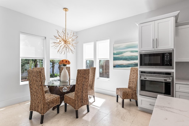 dining space featuring a notable chandelier