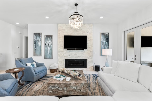 living room with a fireplace, an inviting chandelier, and recessed lighting