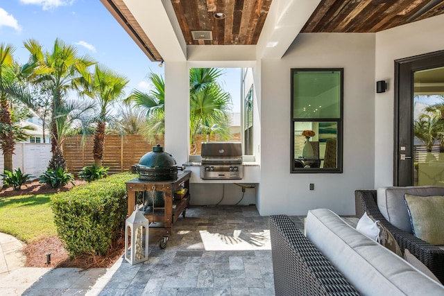 view of patio with a grill, an outdoor living space, and fence