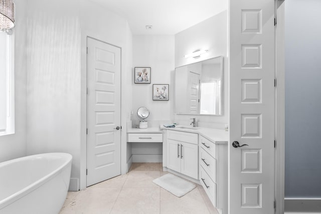 bathroom featuring a soaking tub, tile patterned flooring, and vanity