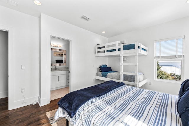 bedroom with recessed lighting, wood finished floors, a sink, baseboards, and visible vents