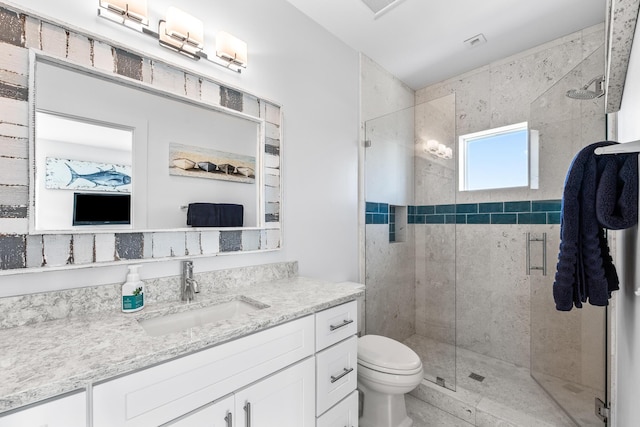 bathroom featuring toilet, a stall shower, visible vents, and vanity