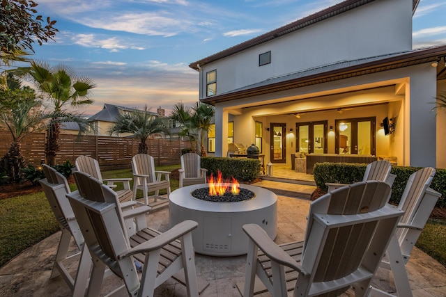 view of patio / terrace with an outdoor fire pit and fence