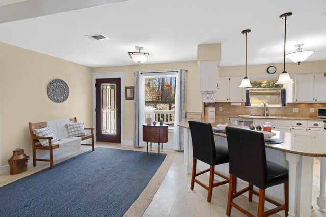 8840 Sand Pine Dr, Navarre, FL 32566 - dining space featuring baseboards and visible vents