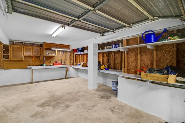 8840 Sand Pine Dr, Navarre, FL 32566 - garage featuring concrete block wall and a workshop area