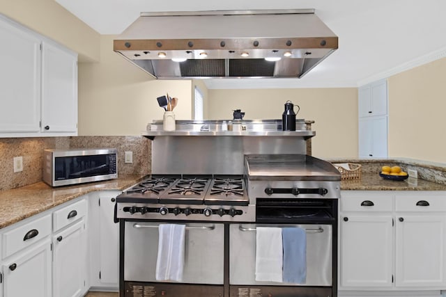 8840 Sand Pine Dr, Navarre, FL 32566 - kitchen with appliances with stainless steel finishes, white cabinetry, and wall chimney exhaust hood