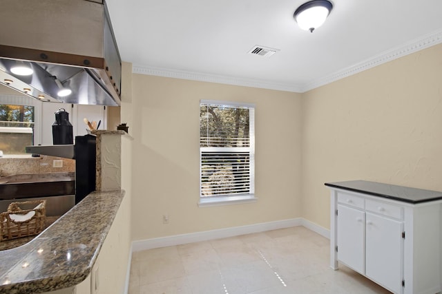 8840 Sand Pine Dr, Navarre, FL 32566 - kitchen featuring visible vents, baseboards, white cabinets, ornamental molding, and dark stone counters