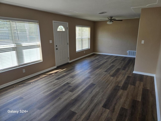 foyer featuring baseboards, visible vents, ceiling fan, and dark wood-type flooring