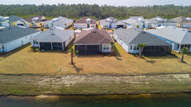 bird's eye view with a wooded view, a water view, and a residential view