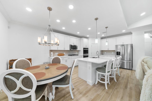 kitchen featuring recessed lighting, a sink, appliances with stainless steel finishes, and tasteful backsplash