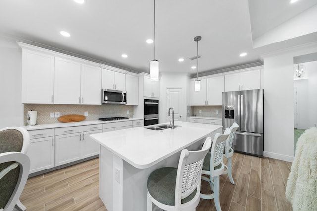 kitchen with recessed lighting, a sink, light wood-style floors, visible vents, and appliances with stainless steel finishes