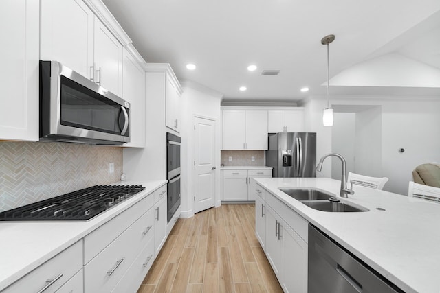 kitchen featuring a sink, visible vents, white cabinetry, light countertops, and appliances with stainless steel finishes