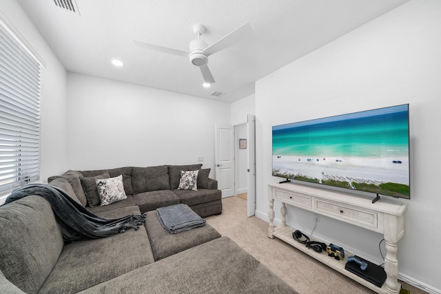 carpeted living room with a ceiling fan, visible vents, and baseboards