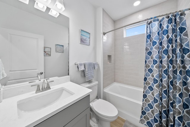 full bath featuring shower / tub combo, toilet, wood finished floors, and vanity