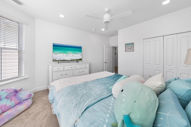 bedroom featuring visible vents, a closet, recessed lighting, light carpet, and multiple windows