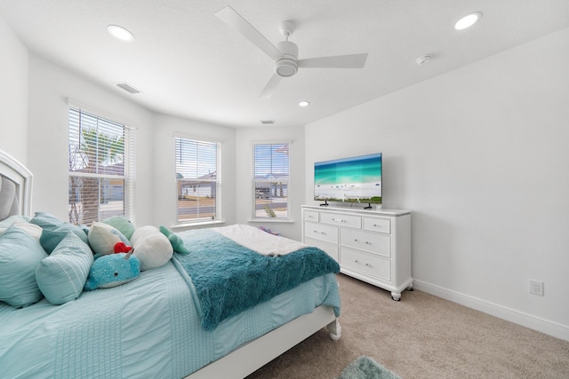 bedroom with light colored carpet, visible vents, baseboards, recessed lighting, and a ceiling fan