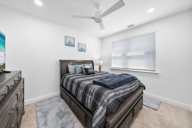 bedroom featuring baseboards, visible vents, ceiling fan, and light colored carpet