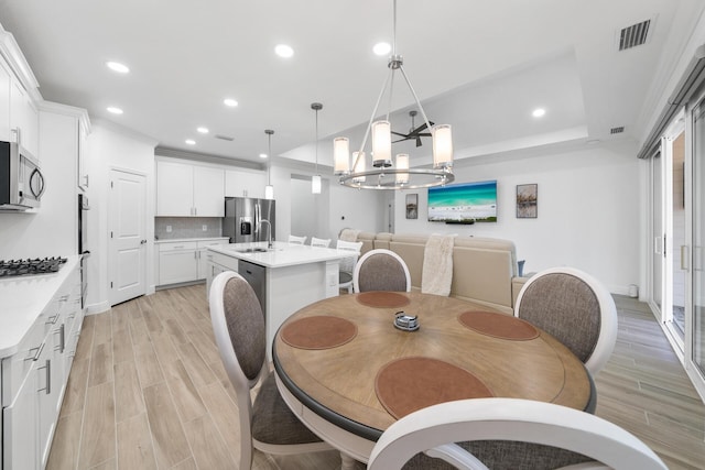 dining room featuring an inviting chandelier, visible vents, recessed lighting, and light wood finished floors