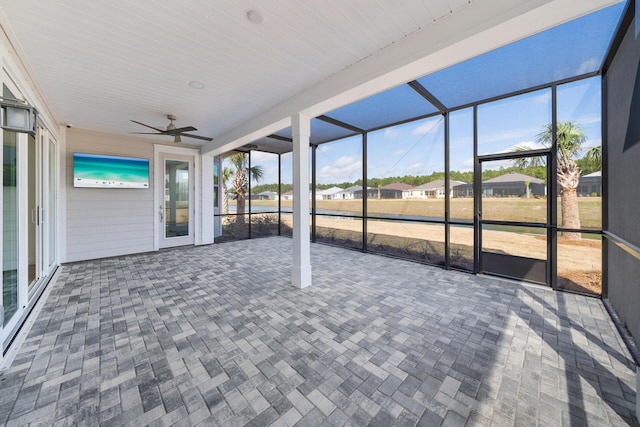 unfurnished sunroom featuring ceiling fan
