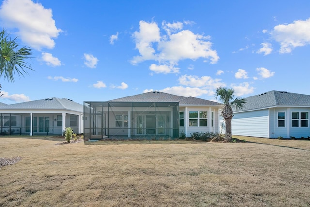 back of property featuring a lawn and a lanai