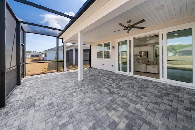 unfurnished sunroom featuring a ceiling fan