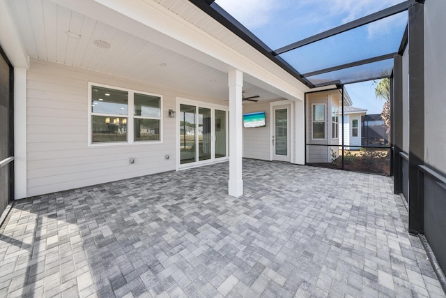 unfurnished sunroom with ceiling fan