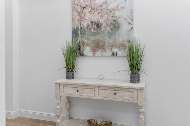 interior details featuring wood finished floors and baseboards