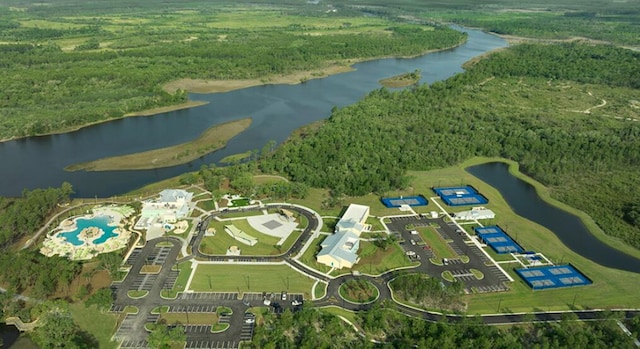 drone / aerial view featuring a forest view and a water view