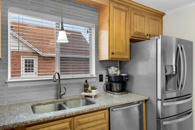 kitchen with stainless steel appliances, a sink, ornamental molding, backsplash, and pendant lighting