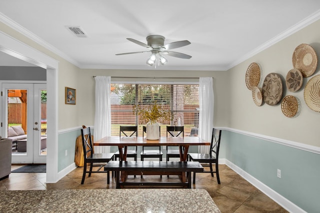 tiled dining room with baseboards, visible vents, french doors, and ornamental molding