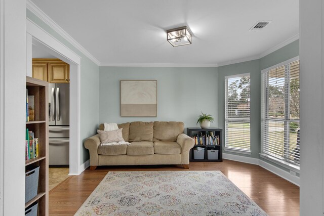 living room featuring visible vents, a wealth of natural light, and wood finished floors