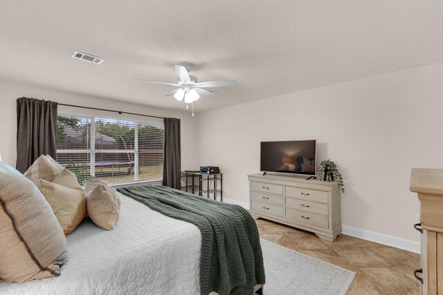 bedroom with baseboards, visible vents, and ceiling fan