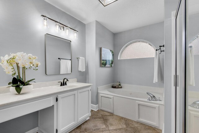 full bathroom with vanity and a bath